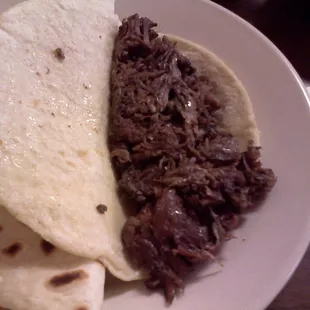 Barbacoa in a corn tortilla