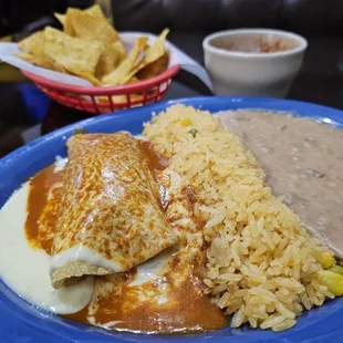 Lunch Enchilada, stuffed with barbacoa, with rice and beans. Excellent!