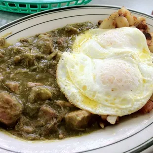 Chili verde with country potatoes and eggs over easy