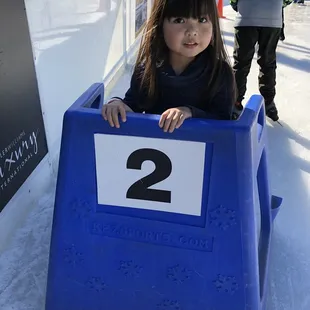 The little girl with the skate buddy