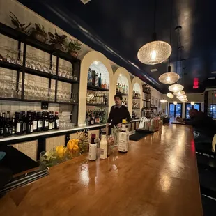 a man behind the bar at a restaurant