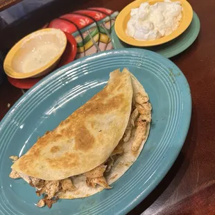 Chicken quesadilla Al la carte with sour cream and queso in the background  Sour Cream Cheese Dip
