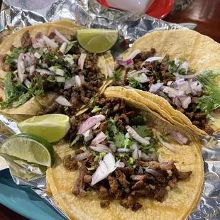Tacos de Carne Asada with Mexican Cheese on the side.