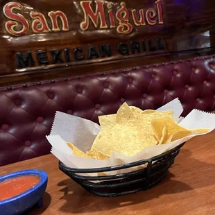 a bowl of nachos and a bowl of salsa