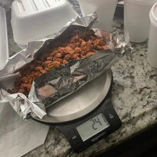 a scale with a tray of food on it