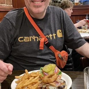 a man sitting at a table with a plate of food