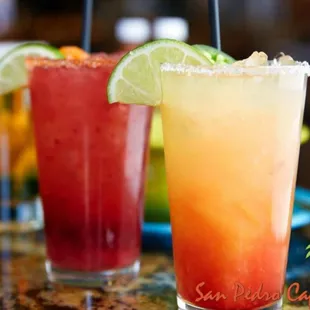 two margaritas with lime wedges