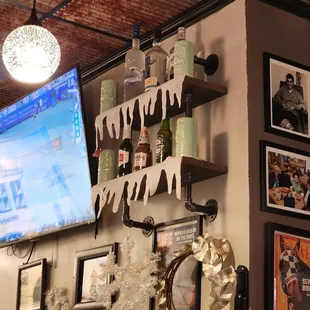 a television and wine bottles on the wall