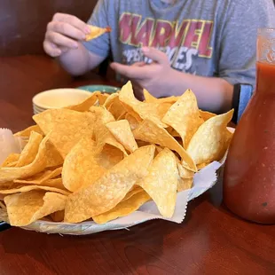 a plate of nachos and a drink