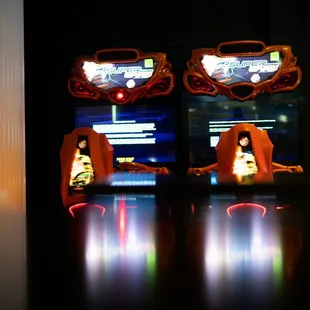 two arcade machines in a dark room