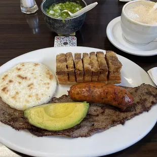 Colombian steak, Colombian sausage, Colombian arepa, and Colombian fried pork belly