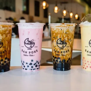 three bubble tea drinks lined up on a table