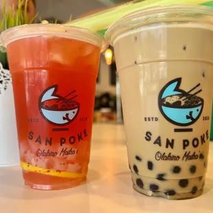 two drinks in plastic cups on a table