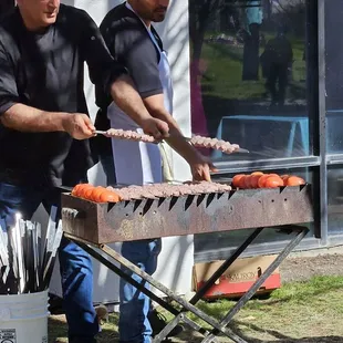Charcoal grill with fresh tomatoes and kabobs