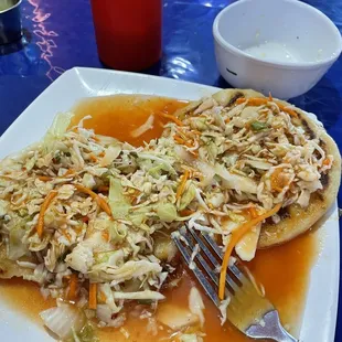 Lorocco and Calabaza pupusas with cabbage and sauce.