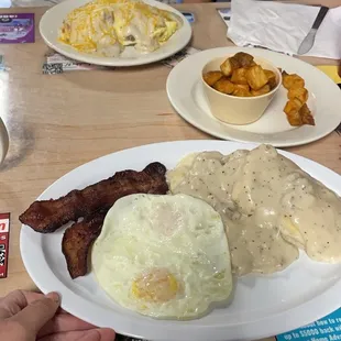 Biscuits and gravy with a side of potatoes and the Chicken Fried Steak Omelet