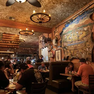 people sitting at tables in a restaurant