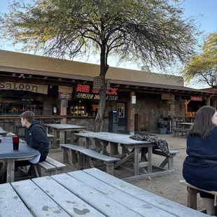 two people sitting at picnic tables