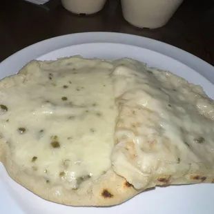 two flatbreads on a white plate