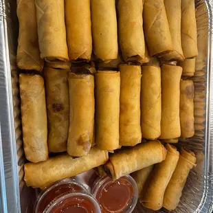a tray of fried spring rolls