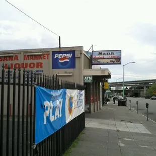 a banner on a fence in front of a store