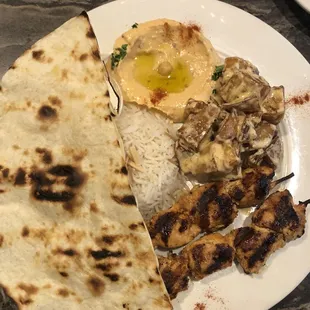 Chicken kabob plate with spicy hummus and roasted potatoes