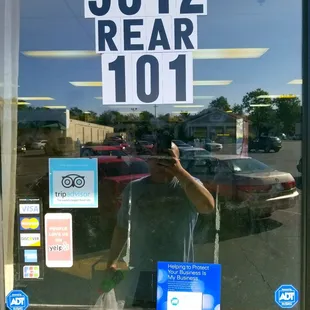 a man taking a selfie in a store window
