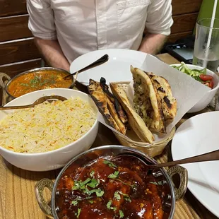 a man sitting at a table full of food