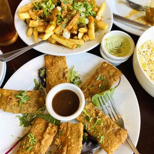 Foreground: Paneer Pakora (deep fried indian cheese ) Background: Masala Fries