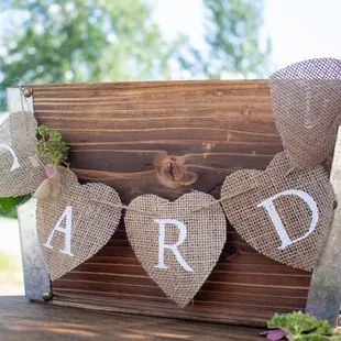 a wooden sign with burlicked hearts