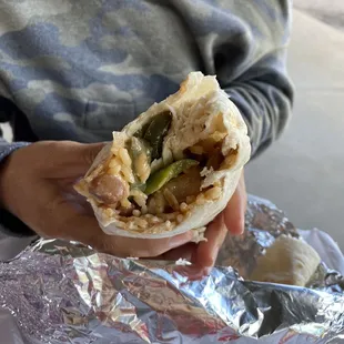 a person holding a burrito