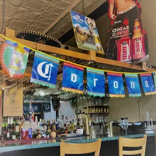 a bar with banners hanging from the ceiling