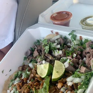 a person holding a tray of food