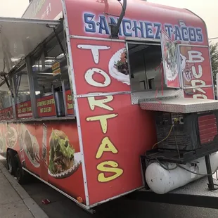 a food truck parked on the side of the road