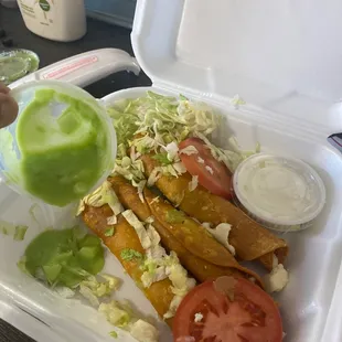 Order of 5 taquitos with yellow old lettuce and very little cheese if u can see it.