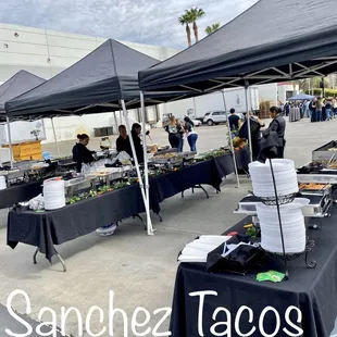 a group of people standing under a tent