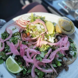 $13.00 for 4 carne asada tacos fully loaded with cilantro ,double tortilla, radish, pickled red onion,salsa Verde, and lime Dam good