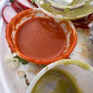 a plate of tacos and sauces