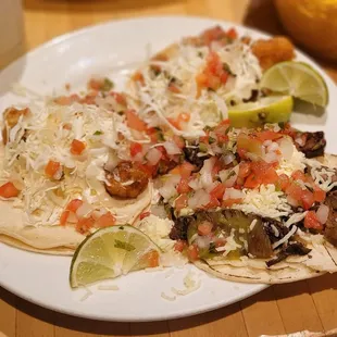 a plate of tacos and a glass of water