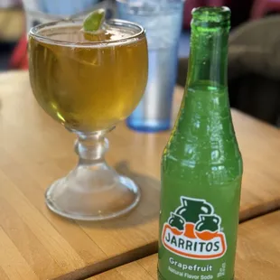 a glass of beer and a bottle on a table