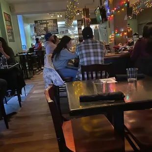 people sitting at tables in a restaurant