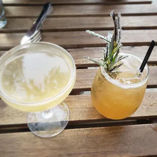 a cocktail with a sprig of rosemary