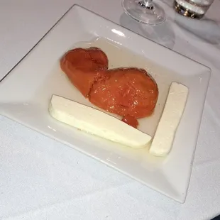 two pieces of cheese and a piece of salmon on a plate