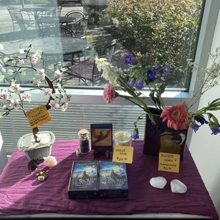  table with a purple tablecloth and a vase of flowers