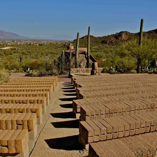 Outdoor seating with a beautiful view of the chapel, hills and surroundings at the Sanctuary Cove.