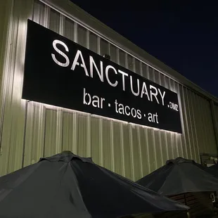 an outdoor bar with umbrellas