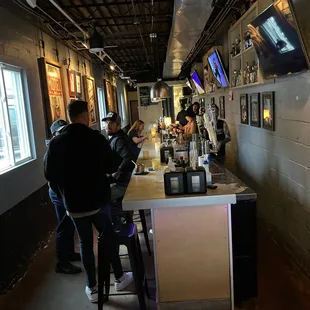 a group of people sitting at a bar