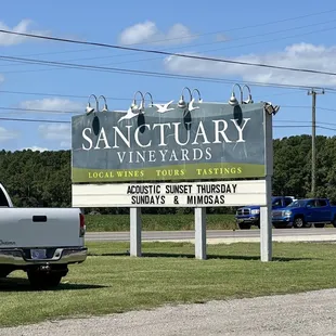 a truck parked in front of a sign