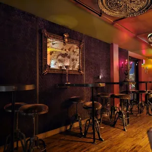 a bar with stools and tables