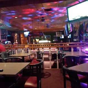 a bar with tables and chairs